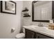 Half bathroom featuring a black framed mirror, marble countertop, decor, and a toilet at 10380 Sand Creek Blvd, Fishers, IN 46037