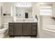 Bathroom featuring a marble countertop, vanity with storage, white cabinets, and natural light at 10380 Sand Creek Blvd, Fishers, IN 46037