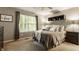 Cozy bedroom featuring a window with natural light, a ceiling fan, and a comfortable bed with neutral tones at 10380 Sand Creek Blvd, Fishers, IN 46037