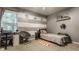 This bedroom has gray and white painted stripes, a bed, a desk, and a comfortable chair at 10380 Sand Creek Blvd, Fishers, IN 46037