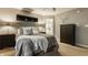 Bedroom with neutral decor featuring a comfortable bed, dark furniture, and natural light from the window at 10380 Sand Creek Blvd, Fishers, IN 46037