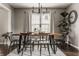 Modern dining room with hardwood floors, a stylish chandelier, and a large wooden table with seating at 10380 Sand Creek Blvd, Fishers, IN 46037