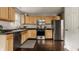 Efficient kitchen layout with stainless steel appliances, hardwood floors, and sleek countertops at 10380 Sand Creek Blvd, Fishers, IN 46037