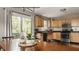 Bright kitchen features hardwood floors, stainless steel appliances, and a breakfast nook by the window at 10380 Sand Creek Blvd, Fishers, IN 46037