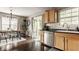Well-lit kitchen with hardwood floors, stainless steel appliances, and a sliding door to the backyard at 10380 Sand Creek Blvd, Fishers, IN 46037
