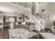 Spacious living room with hardwood floors, a large sectional sofa, and a view of the upper level at 10380 Sand Creek Blvd, Fishers, IN 46037