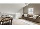 Cozy living room loft area with a comfortable sofa, white railing and a dining table at 10380 Sand Creek Blvd, Fishers, IN 46037