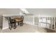 Loft area with dark wood table and chairs overlooking the downstairs area at 10380 Sand Creek Blvd, Fishers, IN 46037