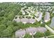 Aerial view of condo community with lush trees, pond, green spaces, and parking areas at 1044 Timber Creek Dr # 2, Carmel, IN 46032