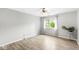 Bedroom with a neutral wall and wood grain floors, featuring a view to the outside from the window at 1044 Timber Creek Dr # 2, Carmel, IN 46032