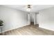 Bedroom with neutral wall and wood grain floors, a ceiling fan and several entry doors at 1044 Timber Creek Dr # 2, Carmel, IN 46032