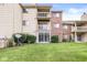 Back exterior of a multi-Gathering building with well-maintained lawn and some greenery at 1044 Timber Creek Dr # 2, Carmel, IN 46032