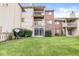 Building exterior with sliding glass door leading to the lawn with plants and a satellite dish at 1044 Timber Creek Dr # 2, Carmel, IN 46032