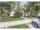 Charming condo exterior with lush landscaping, private balconies, and convenient parking at 1044 Timber Creek Dr # 2, Carmel, IN 46032
