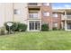 Back exterior featuring sliding doors leading to a lawn with well-maintained plants at 1044 Timber Creek Dr # 2, Carmel, IN 46032