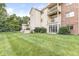 Well-maintained condominium building with a manicured lawn and a private patio at 1044 Timber Creek Dr # 2, Carmel, IN 46032