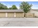 Individual garages with neutral doors, ample parking space, and secure access at 1044 Timber Creek Dr # 2, Carmel, IN 46032