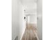 Hallway with light gray walls and wood grain laminate flooring at 1044 Timber Creek Dr # 2, Carmel, IN 46032