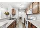 Traditional kitchen featuring wood cabinets, white countertops, and modern appliances at 1044 Timber Creek Dr # 2, Carmel, IN 46032