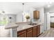 Kitchen with wooden cabinets, laminate countertops, and stainless steel sink with view to living area at 1044 Timber Creek Dr # 2, Carmel, IN 46032