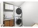 Functional laundry area with stacked washer and dryer and cabinet storage at 1044 Timber Creek Dr # 2, Carmel, IN 46032