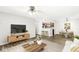 Cozy living room with open kitchen view, hardwood floors, and natural light from the window at 1044 Timber Creek Dr # 2, Carmel, IN 46032