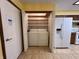 Laundry area features a washer and dryer with built-in shelving in a closet at 10976 Mt Vernon N Trl, Indianapolis, IN 46229