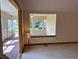 Living room featuring open layout and opening to bright sunroom with large windows and carpet at 10976 Mt Vernon N Trl, Indianapolis, IN 46229