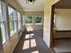 Bright sunroom featuring large windows offering ample natural light and outdoor views at 10976 Mt Vernon N Trl, Indianapolis, IN 46229
