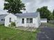 Charming single-story home with a white exterior and well-maintained front yard at 1102 S Dequincy St, Indianapolis, IN 46203