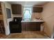 Traditional kitchen featuring dark wood cabinets and essential appliances at 1102 S Dequincy St, Indianapolis, IN 46203