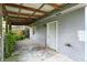 Covered back porch with concrete flooring, ideal for outdoor activities at 1120 W 5Th St, Greenfield, IN 46140