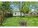 The backyard offers a fire pit, lush greenery, and ample space at 1120 W 5Th St, Greenfield, IN 46140
