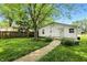 The backyard is well-manicured with mature trees surrounding the home at 1120 W 5Th St, Greenfield, IN 46140
