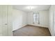 This cozy bedroom features neutral carpet and a single window for natural light at 1120 W 5Th St, Greenfield, IN 46140