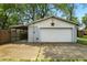 View of the garage with a white door, a red star, and a concrete driveway at 1120 W 5Th St, Greenfield, IN 46140