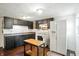 Bright kitchen with dark cabinetry, modern appliances, and ample counter space, creating a functional cooking area at 1120 W 5Th St, Greenfield, IN 46140