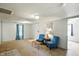 Comfortable living room with bright lighting, carpeting, and cozy seating, ideal for relaxing and entertaining guests at 1120 W 5Th St, Greenfield, IN 46140