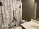 Bathroom featuring a Paris-themed shower curtain, single sink vanity, and neutral walls at 1128 Brookside Ct, Avon, IN 46123