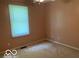 This bedroom features a bright window and neutral carpeting throughout at 1128 Brookside Ct, Avon, IN 46123