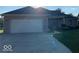 Charming single-story home with a brick facade, well-maintained lawn, and attached two-car garage at 1128 Brookside Ct, Avon, IN 46123