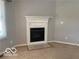 Cozy fireplace with a white mantel creating a warm and inviting focal point in the living space at 1128 Brookside Ct, Avon, IN 46123