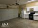 Spacious garage equipped with a functional kitchenette area, and garage door at 1128 Brookside Ct, Avon, IN 46123