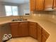 Well-lit kitchen featuring light countertops, stainless steel appliances, and wood cabinets at 1128 Brookside Ct, Avon, IN 46123