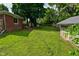 Expansive backyard featuring a shed, brick house, and plenty of space for outdoor enjoyment at 11522 Newport Dr, Indianapolis, IN 46236