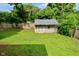 Backyard view featuring a storage shed and a fenced perimeter for privacy at 11522 Newport Dr, Indianapolis, IN 46236