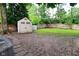 Spacious backyard with a shed and some partially muddy spots at 11522 Newport Dr, Indianapolis, IN 46236