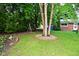 Landscaped backyard with mature trees and a swing, perfect for outdoor relaxation at 11522 Newport Dr, Indianapolis, IN 46236