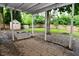 Covered backyard patio area with an outdoor storage box and access to the yard at 11522 Newport Dr, Indianapolis, IN 46236