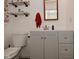 Bathroom with gray vanity, white countertops, and floating shelves at 11522 Newport Dr, Indianapolis, IN 46236